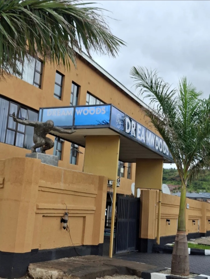 DreamWoods hotel building with palm trees in Masvingo